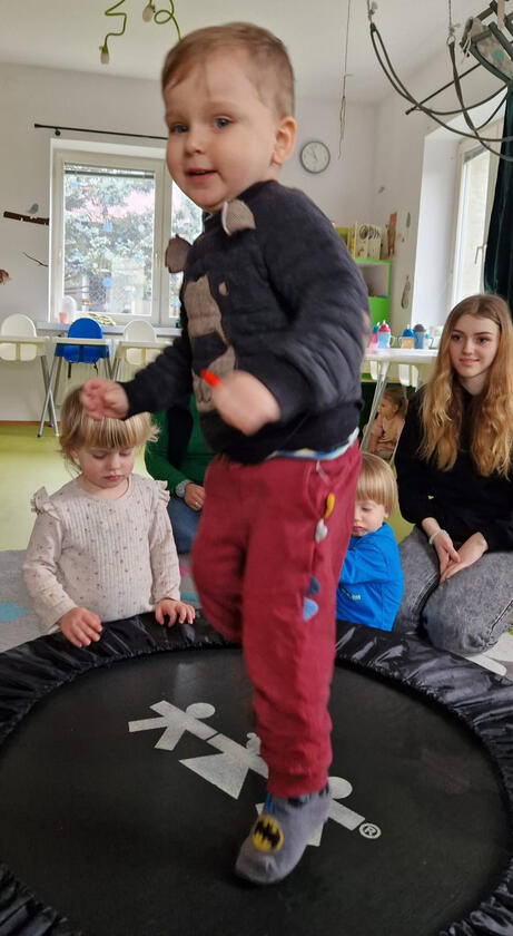 Untitled Boy jumping on the trampoline in the room at Mariposa Nursery