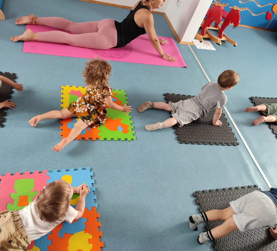 Untitled Children practicing yoga in the room at Mariposa Nursery